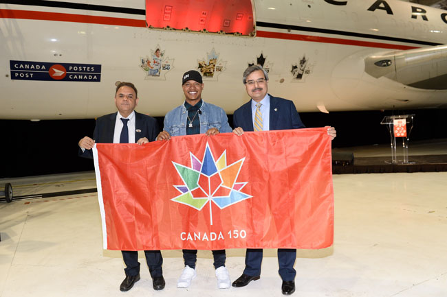 Indiduals holding flag in front of airplane